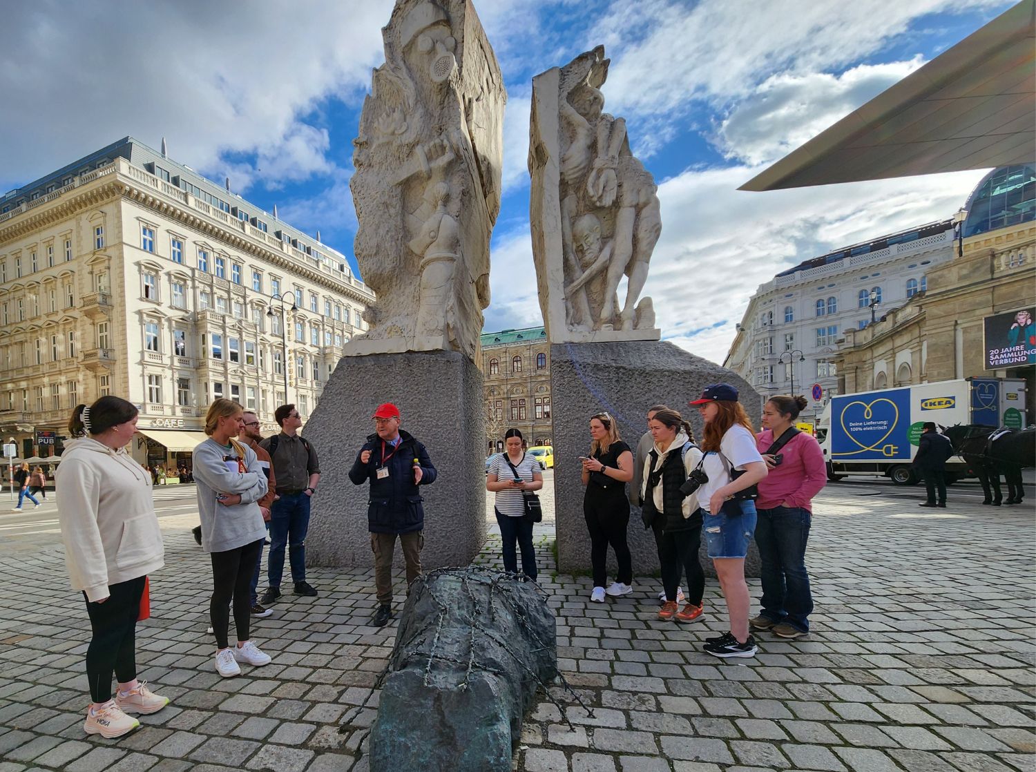 A group of students gathered around a tour guide in Germany