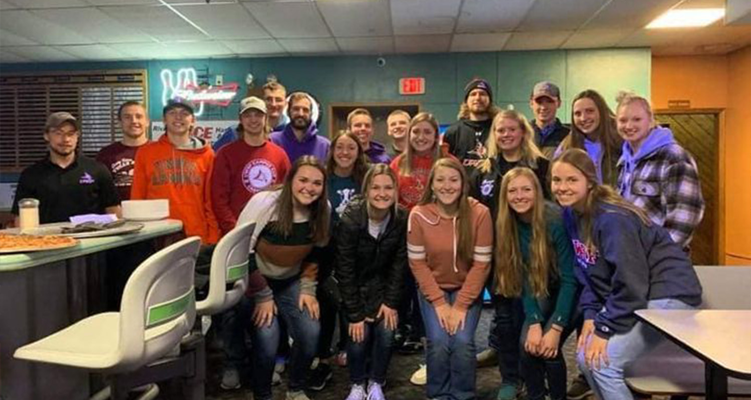 Agricultural Business and Marketing Society students pose in a bowling alley during a group activity