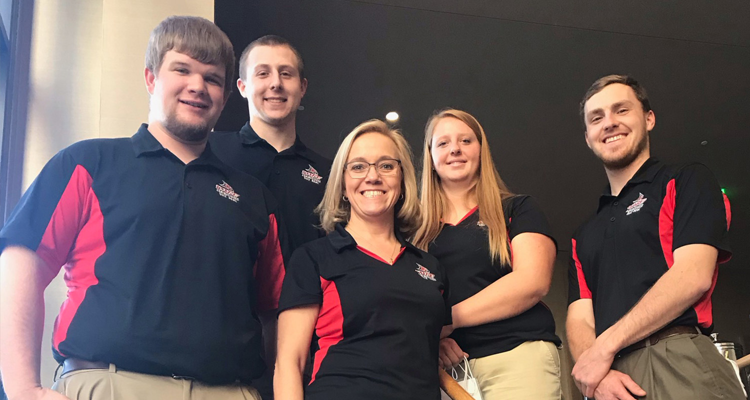 Five Quiz bowl students stand together at a competition