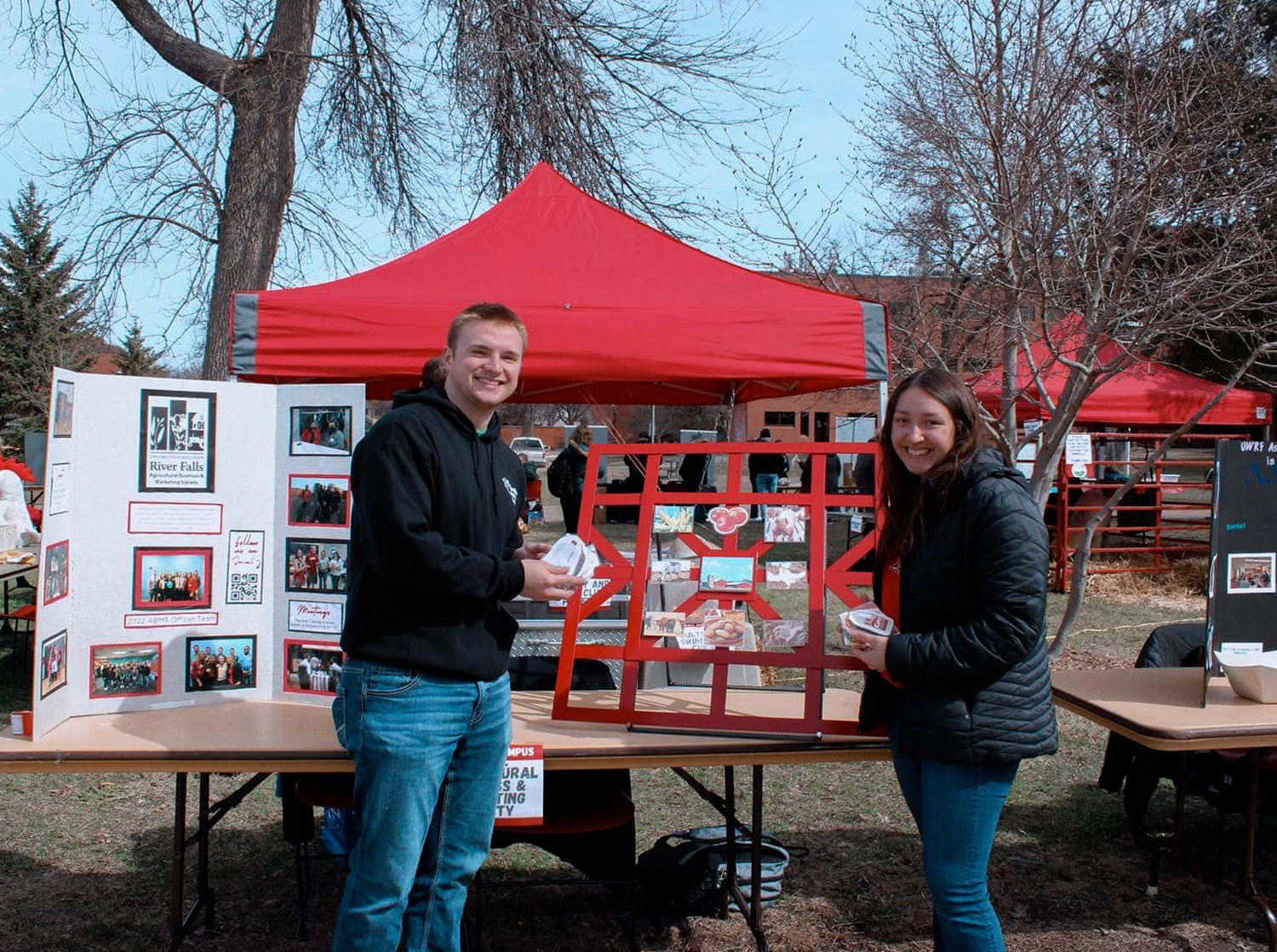 Two students stand at a display booth during Ag day on campus