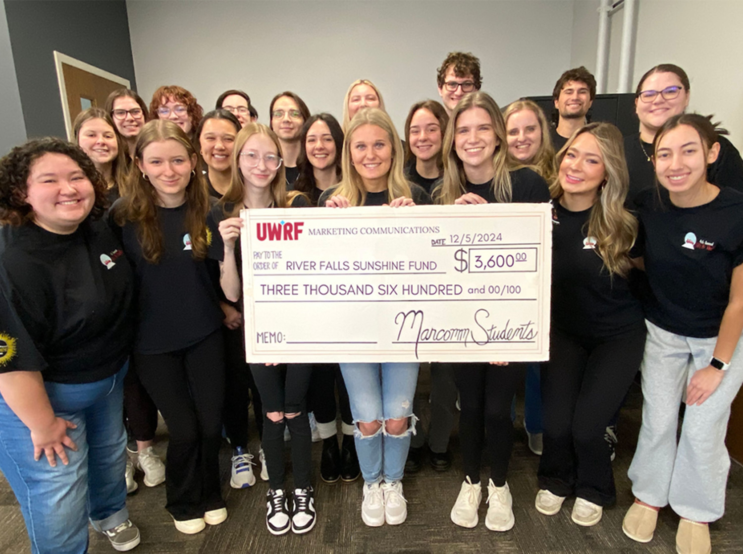 COMMS Students holding Large Check