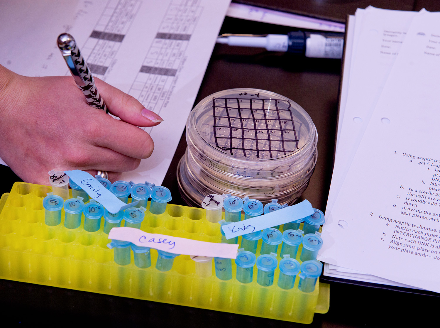 Petri dishes and small vials cover a lab table