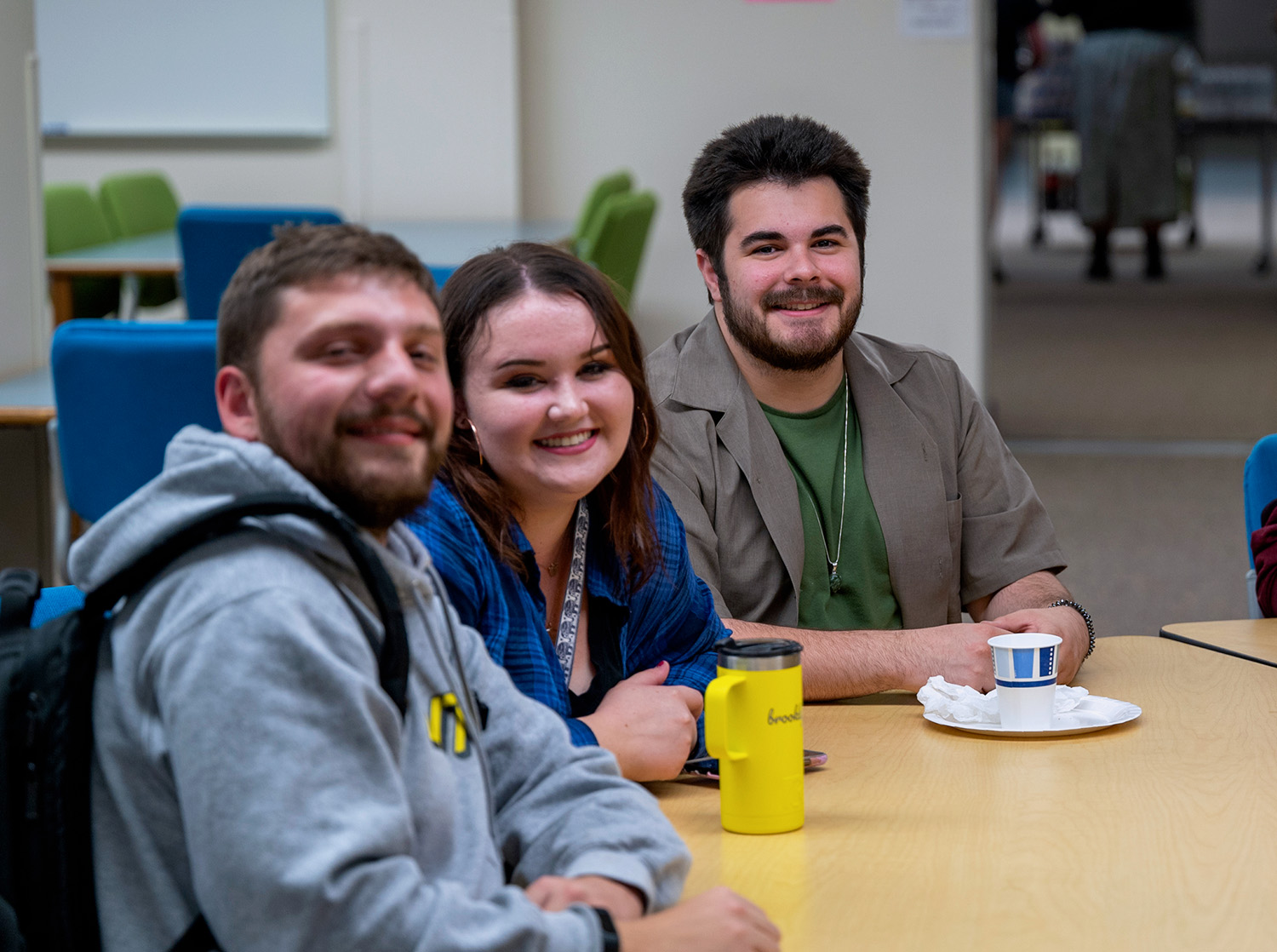 Three students sit together in the Chalmer Davee Library