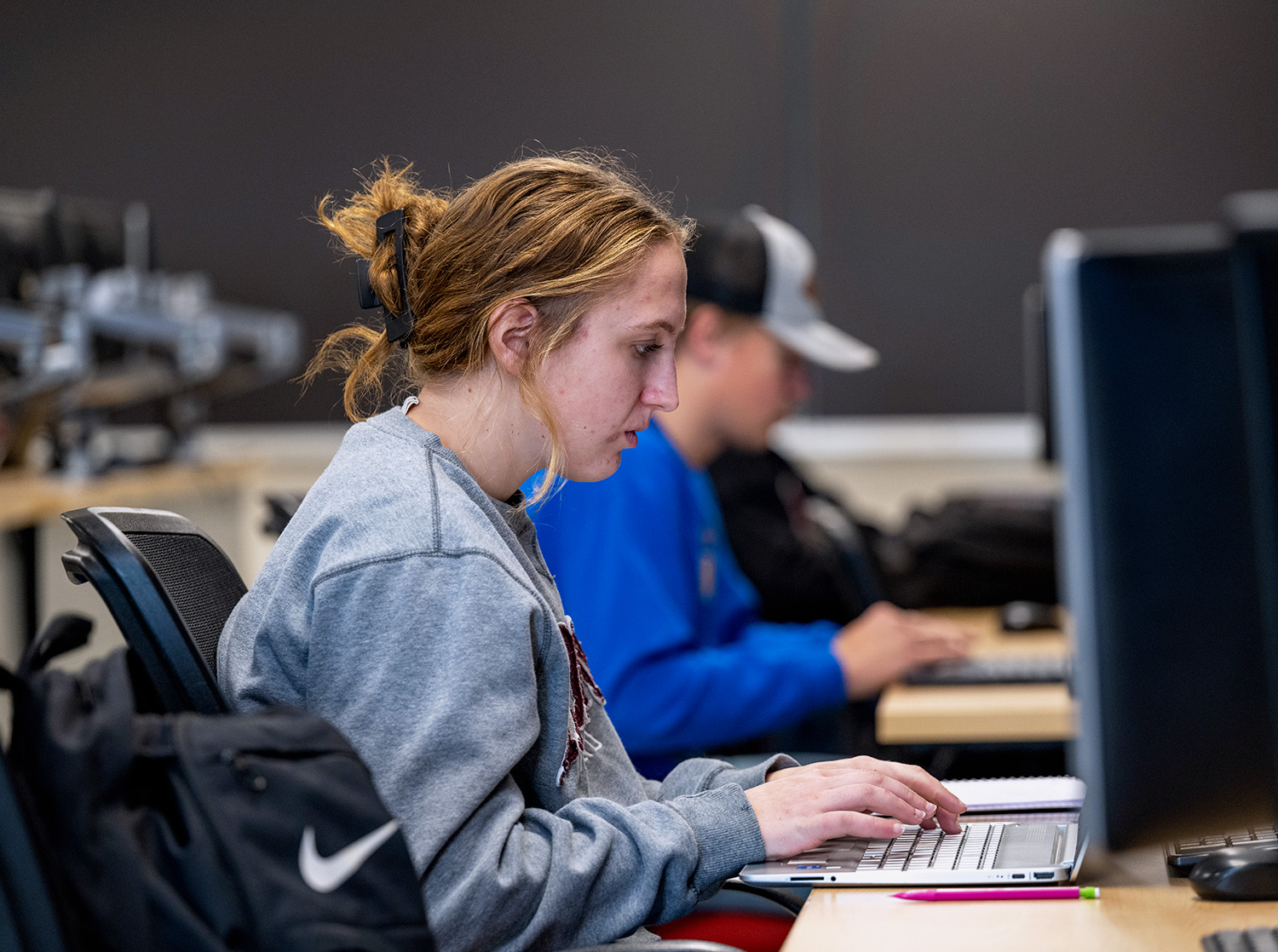A female student works on a computer in the lab
