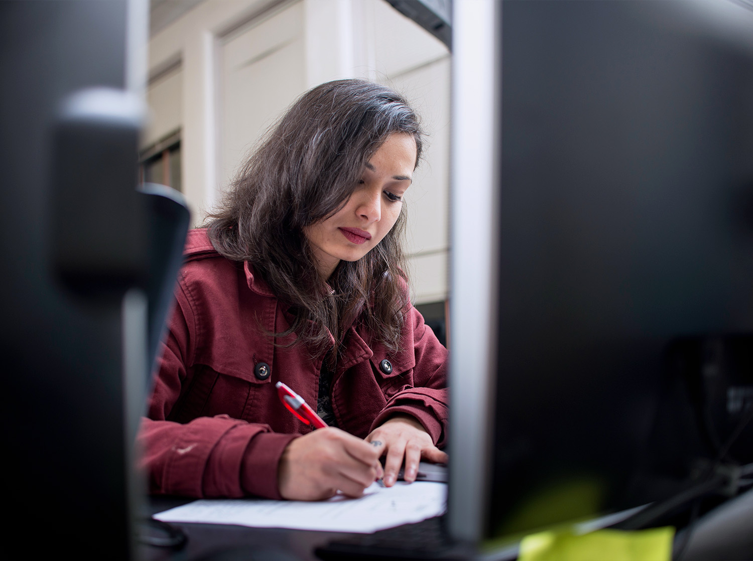 A female student writes in a notebook