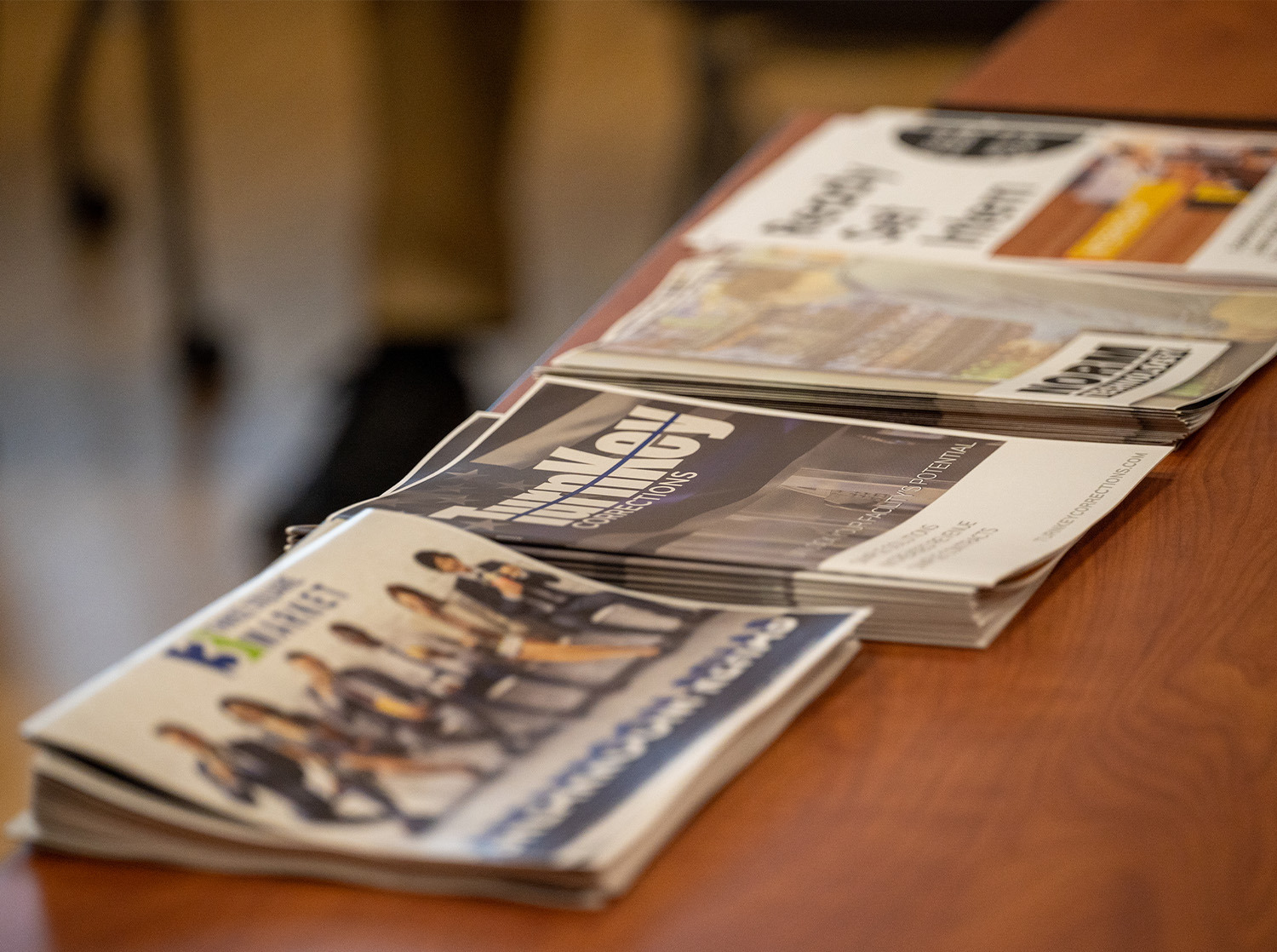 Multiple stacks of newspapers sit on a table