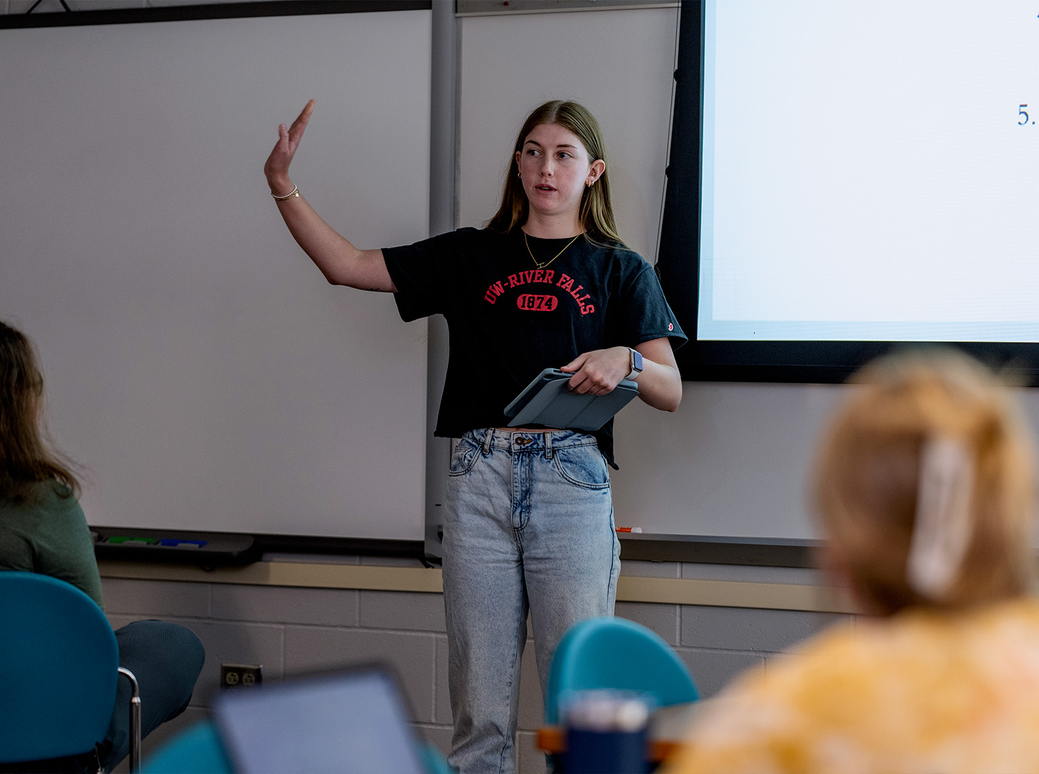 A female student give a presentation during class