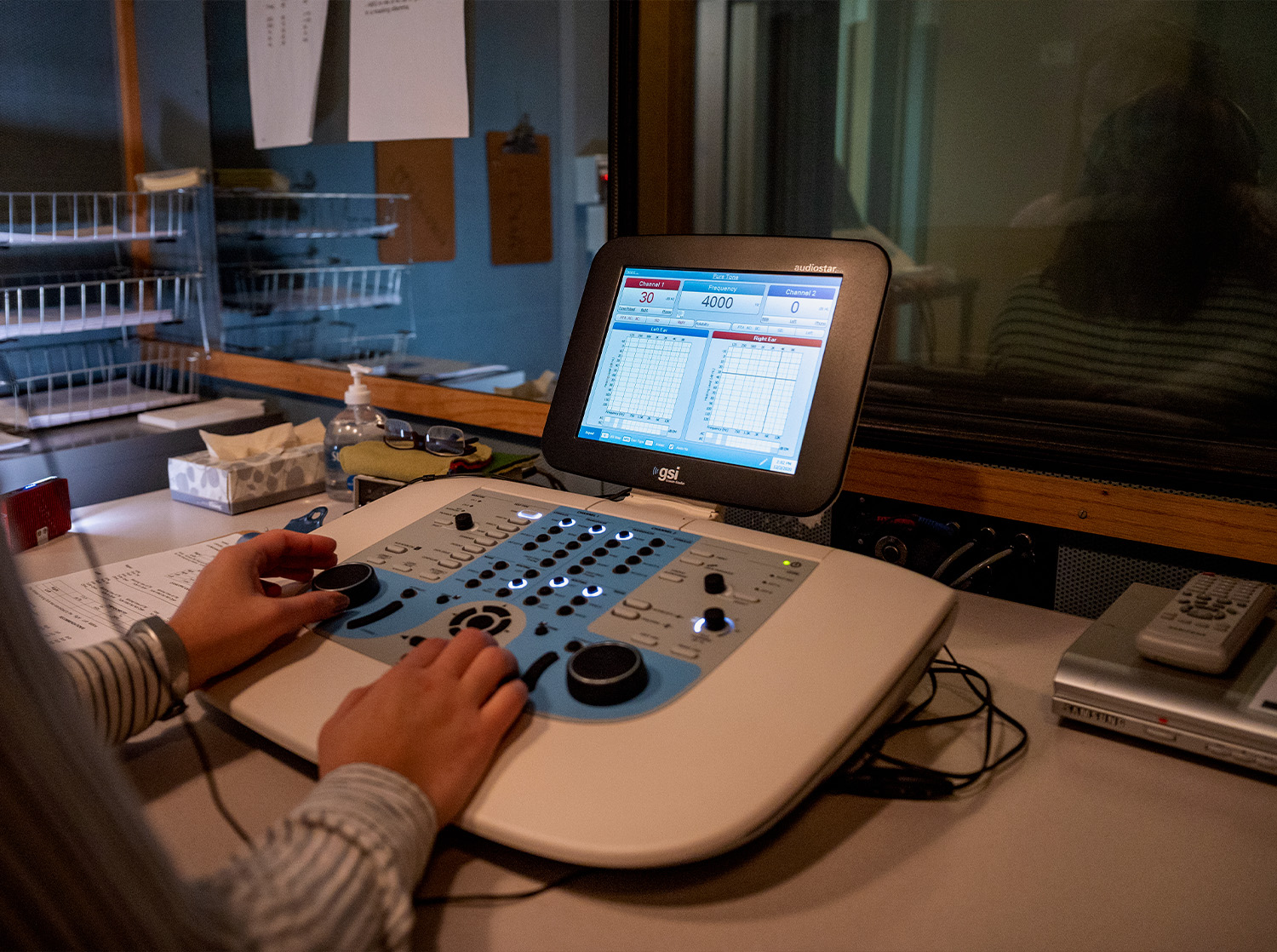 A student uses an audio device to test the hearing of another student