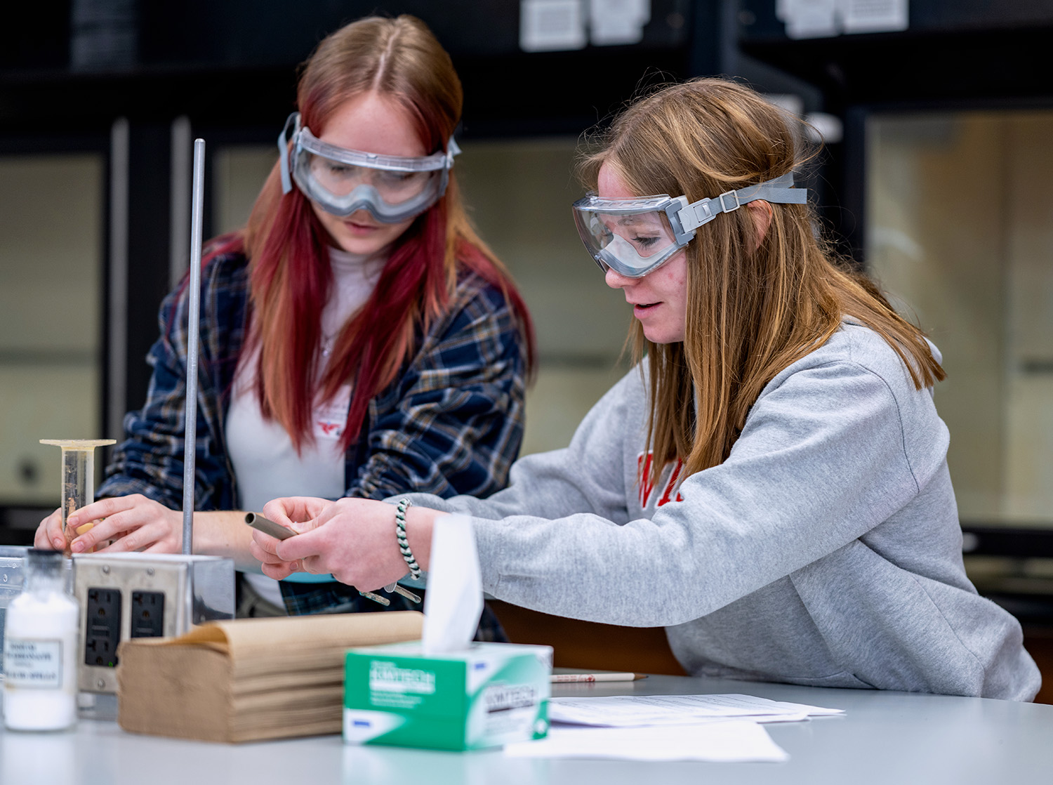 Two female students work on a lab exercise during class