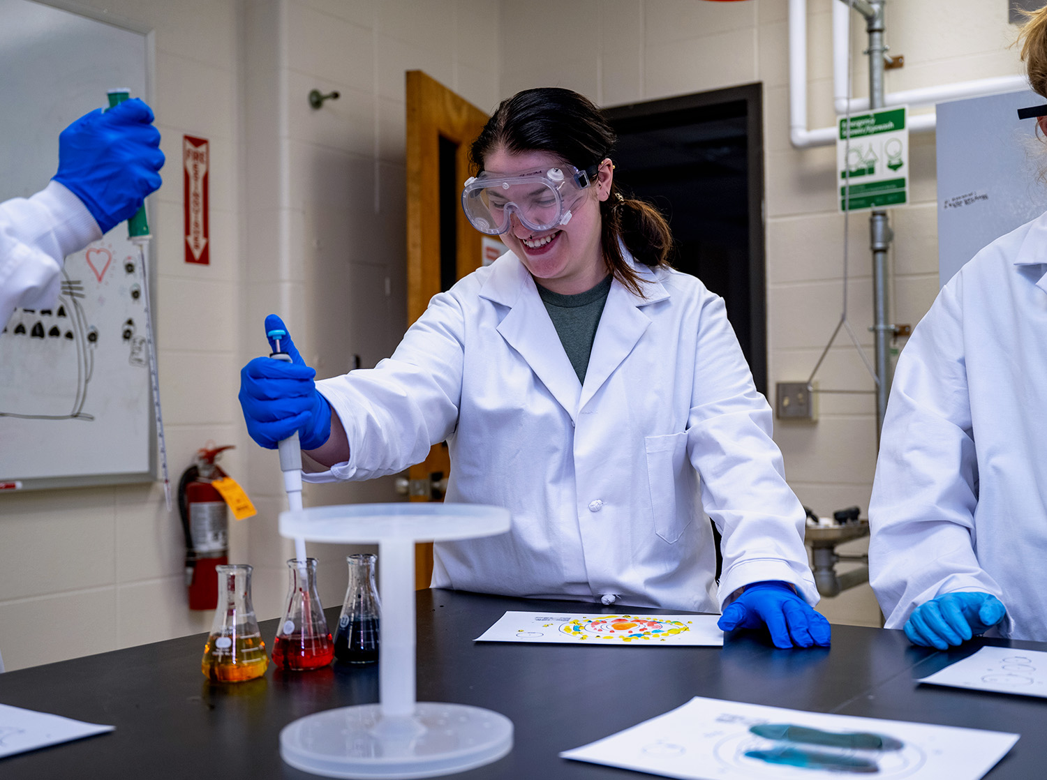 A student smiles during a lab exercise