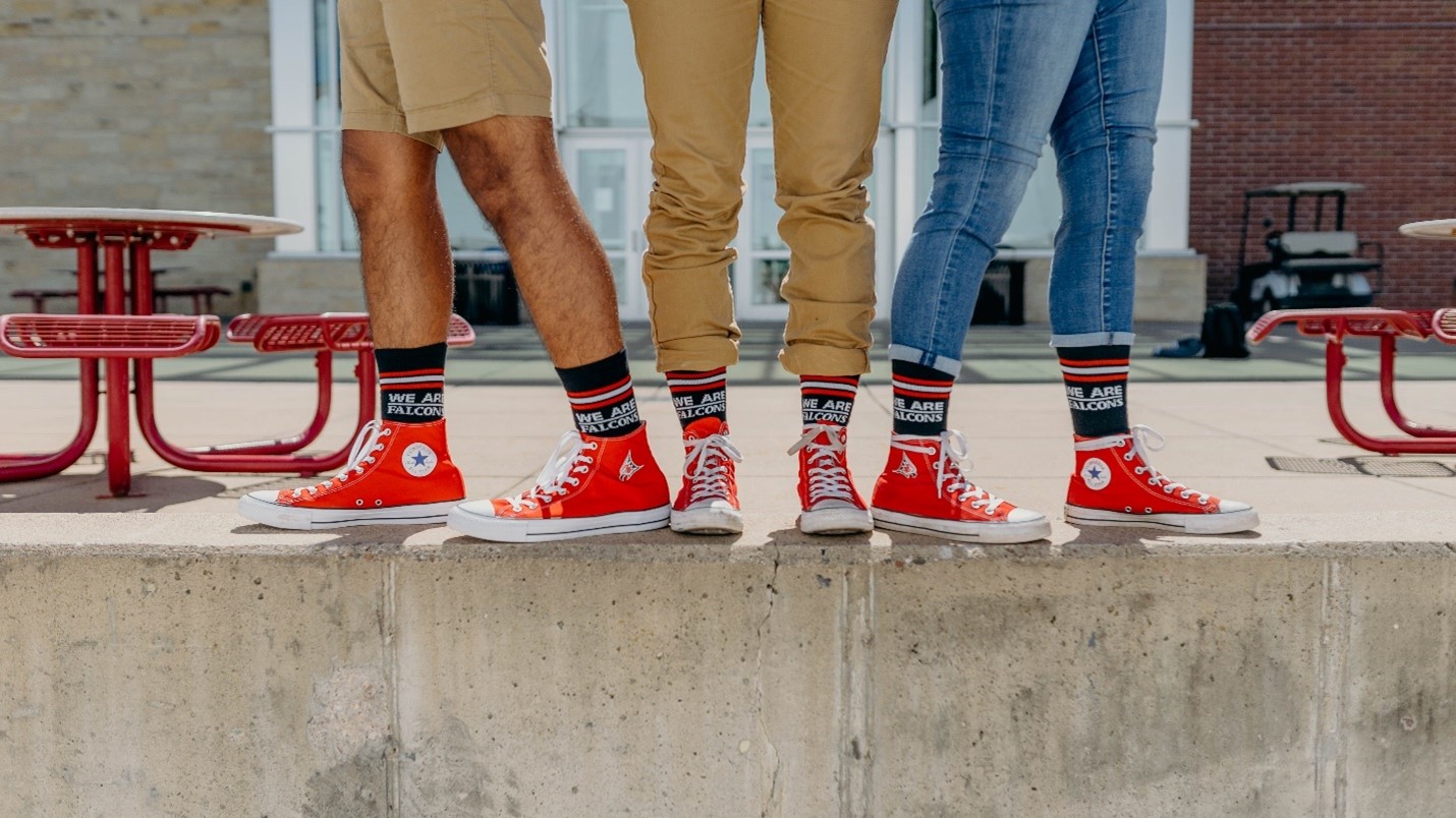 Three students wear the Falcon Five converse shoes