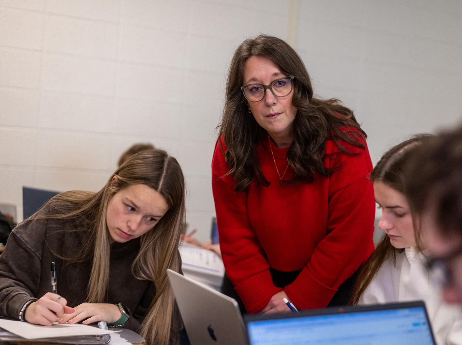 A female professor listens to a student during a victimology class lecture