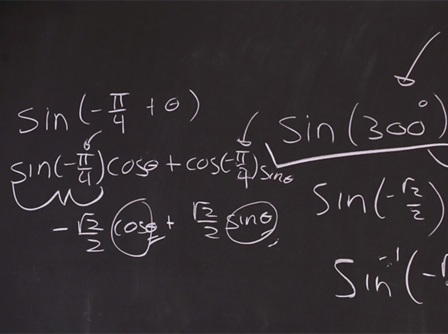 A math problem is written on a blackboard with white chalk