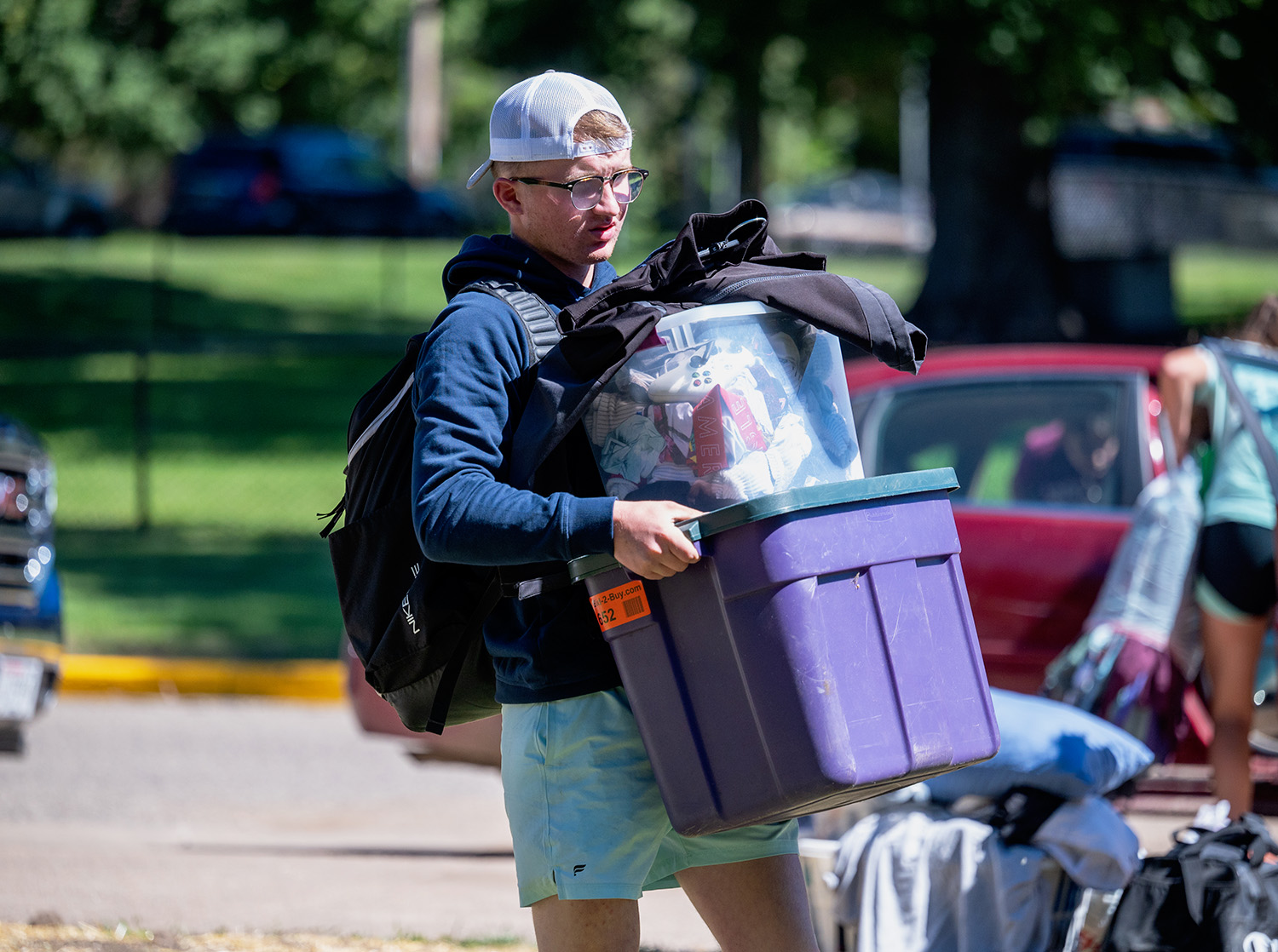 A first year student moves their belongings into a residence hall