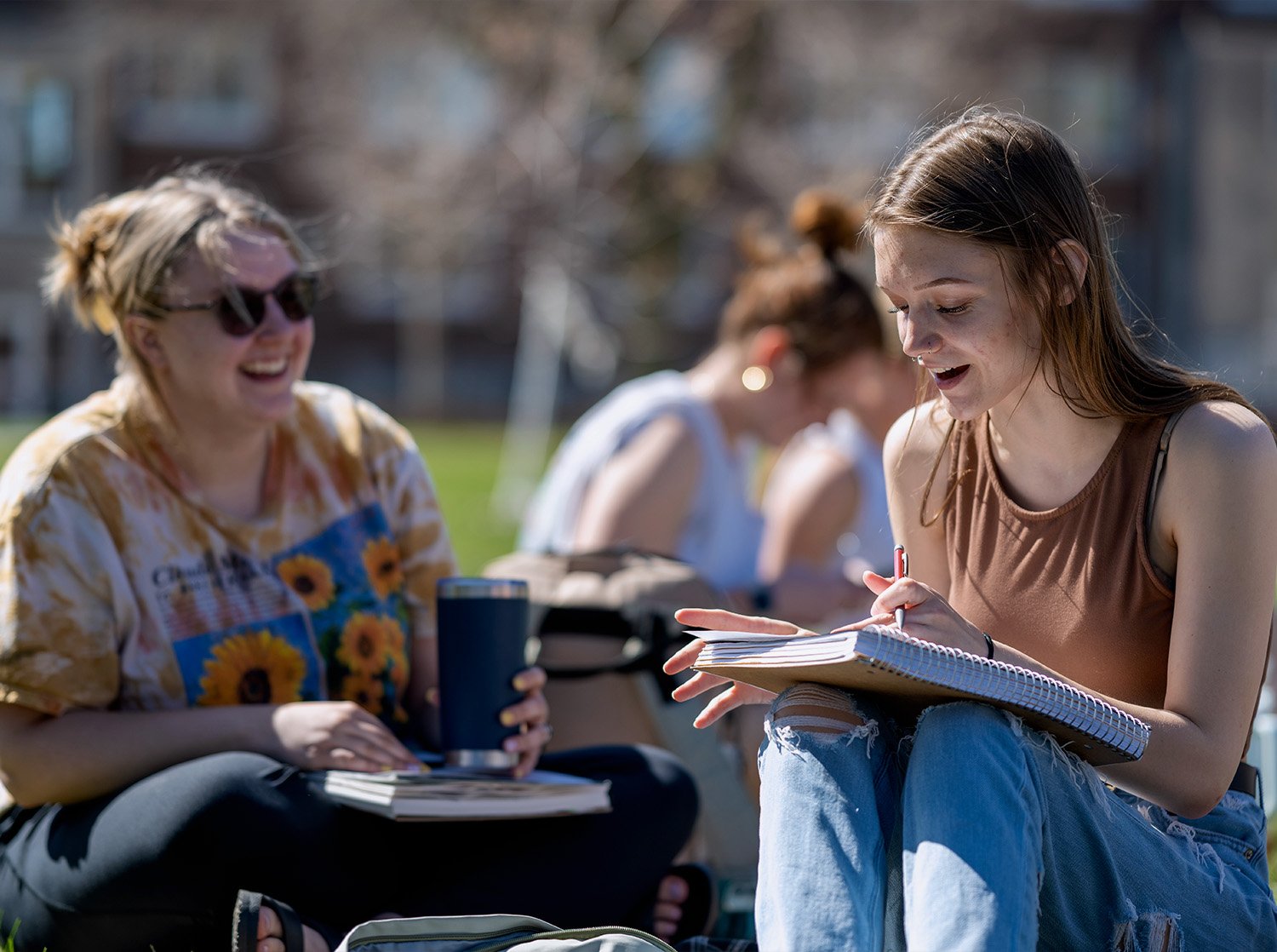 Two female students talk during class outside