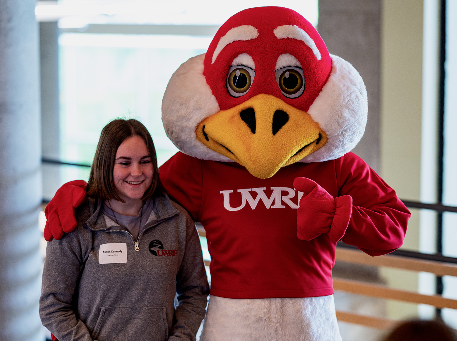 Freddy Falcon poses with a student during summer orientation