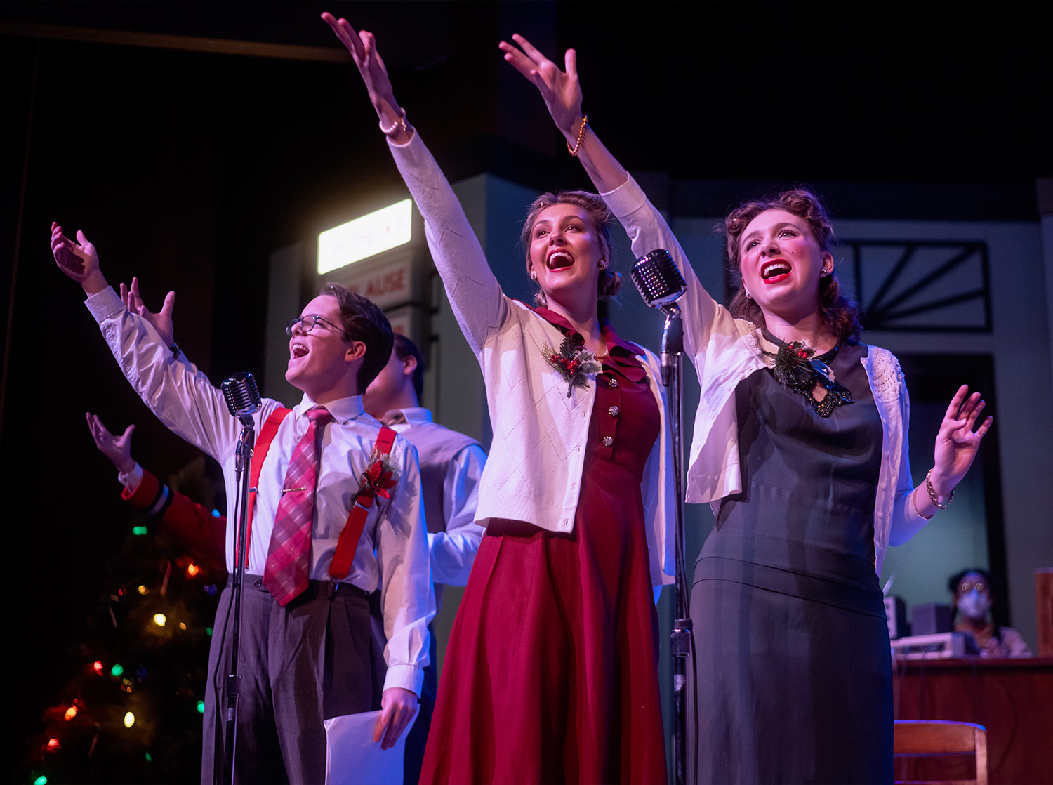 Three performers sing during the Christmas Carol play