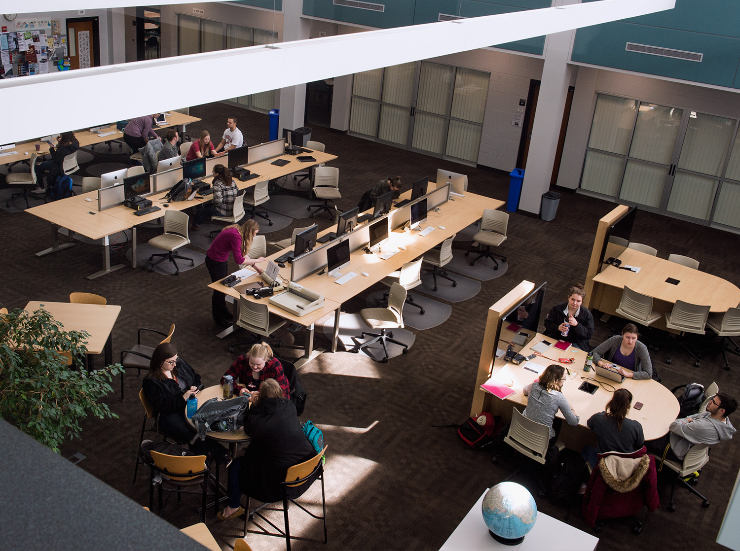 Multiple students study at various tables in the Wyman Education Building (WEB)