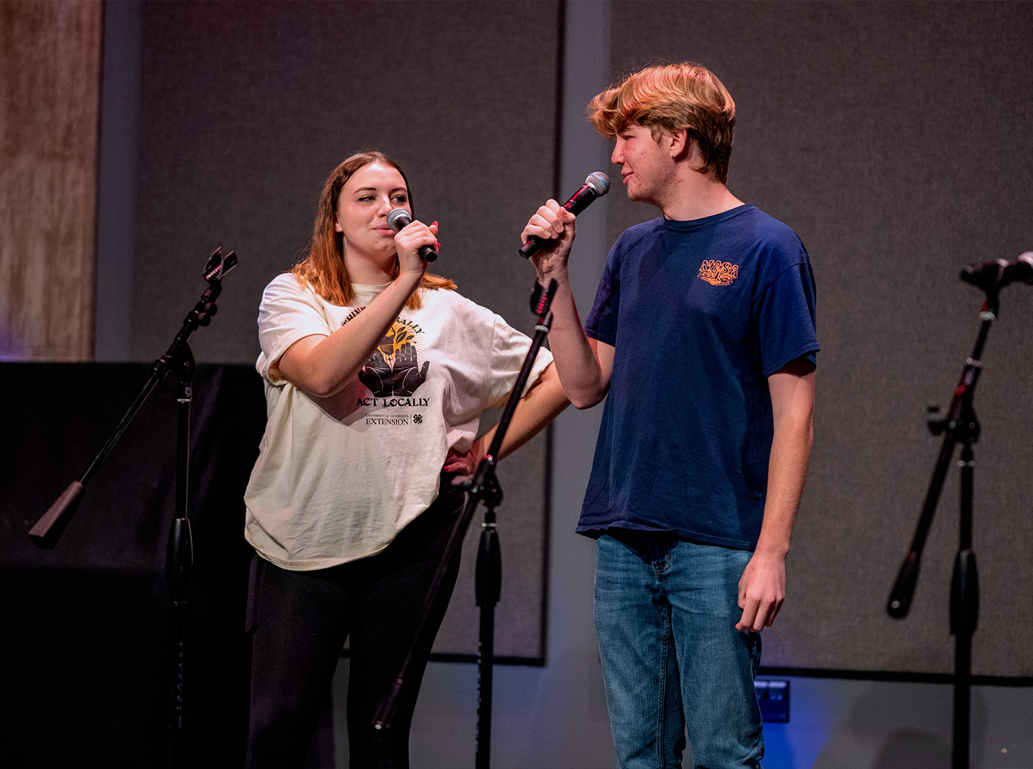 Two students speak into microphones during Family Fun Night