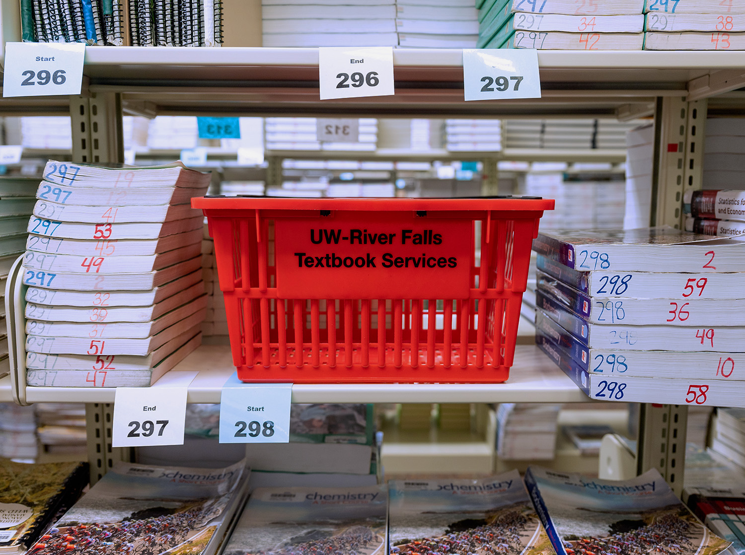 Shopping basket sitting on a bookshelf in textbook services