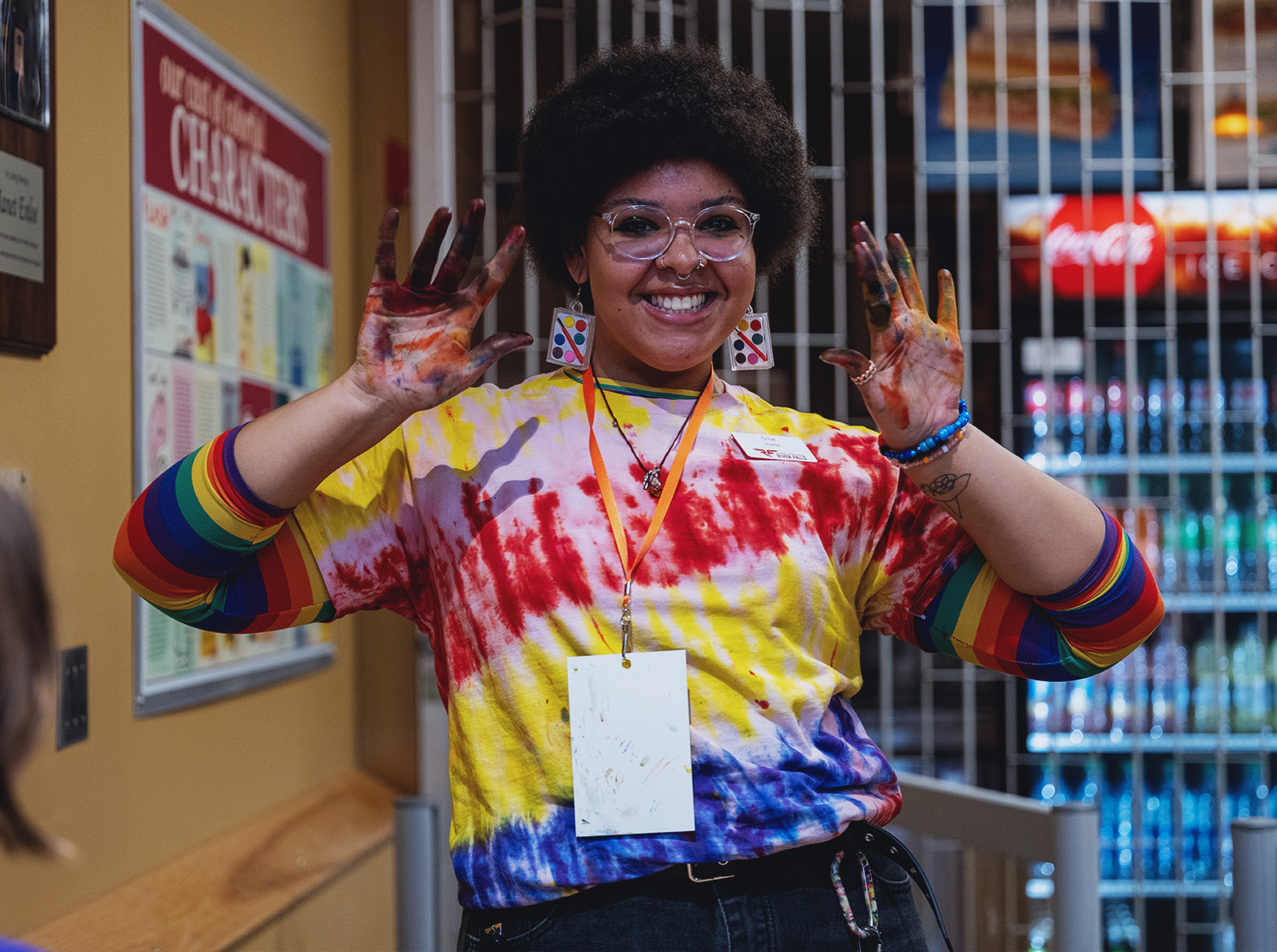 A student shows off their finger-painting skills during finals fest