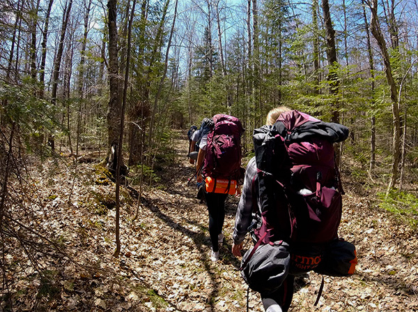 A group of students backpack along a trail in St. Croix County