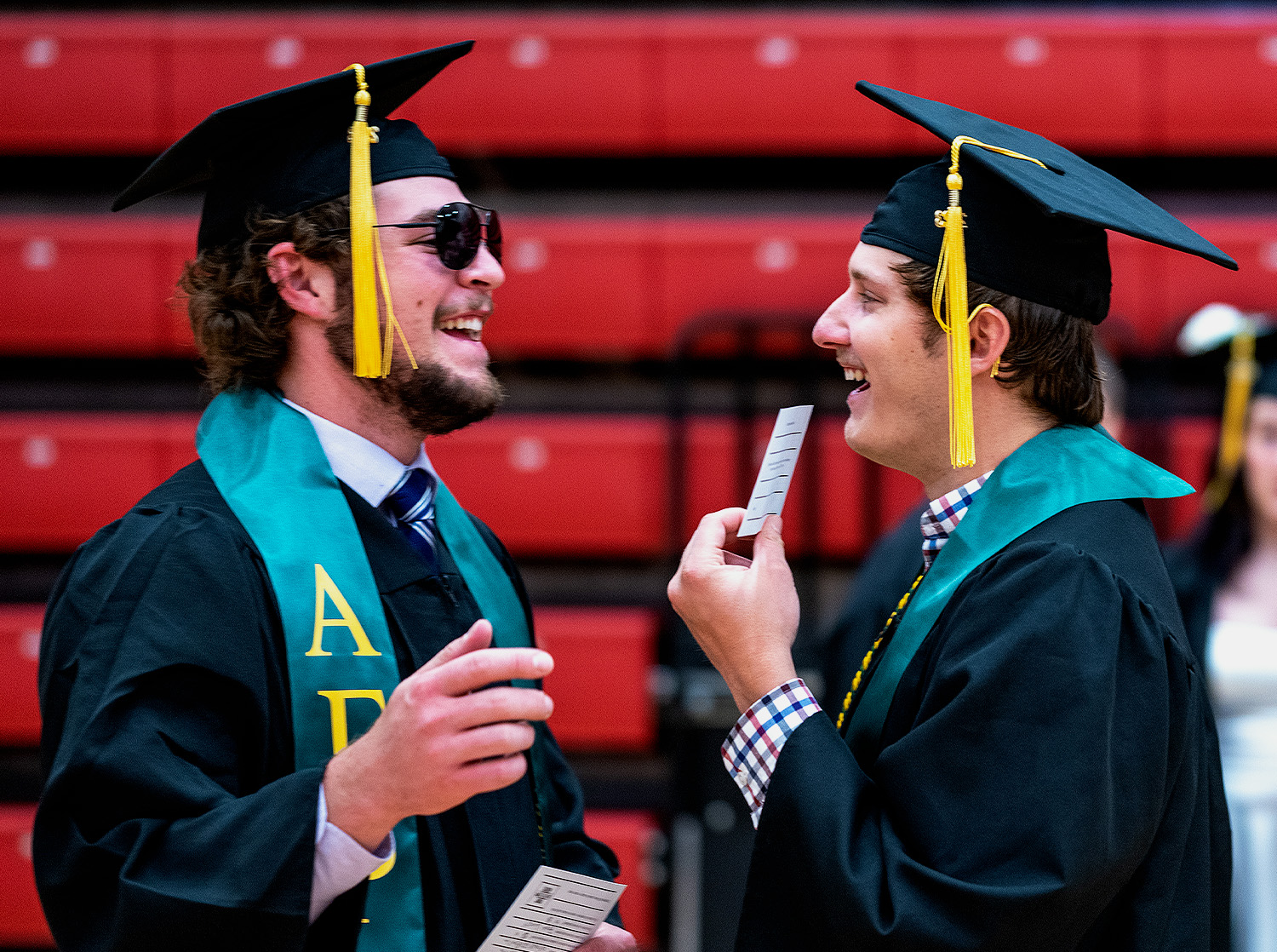 Two graduates talk to each other before the ceremony