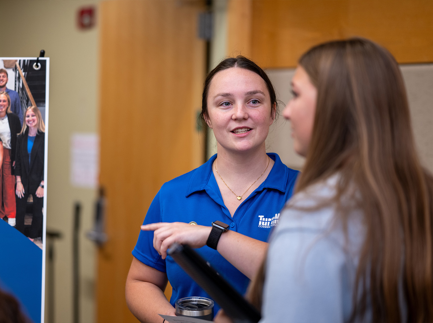 A female employer from TurnKey talks to a student during the Career Fair