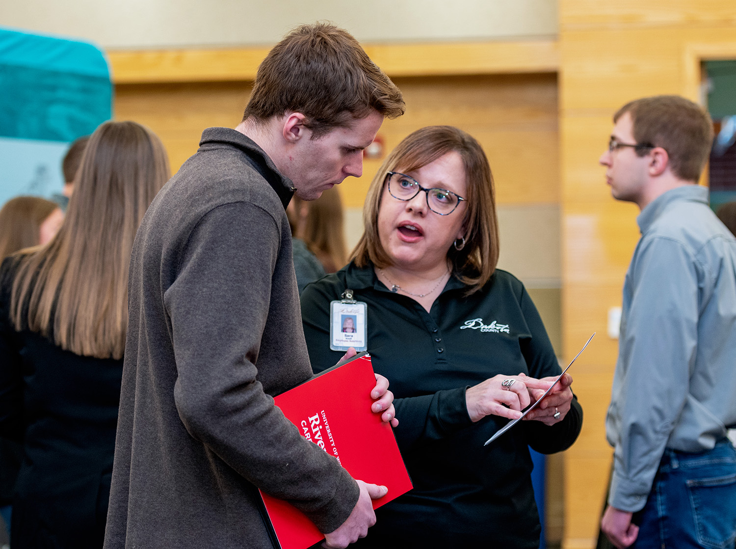An employer speaks to a student during the career and internship fair