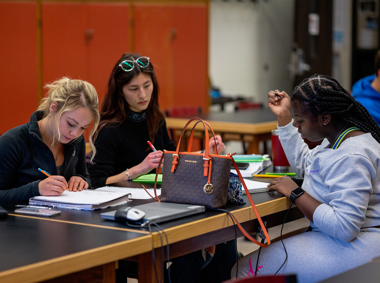 Three students attend a tutoring session