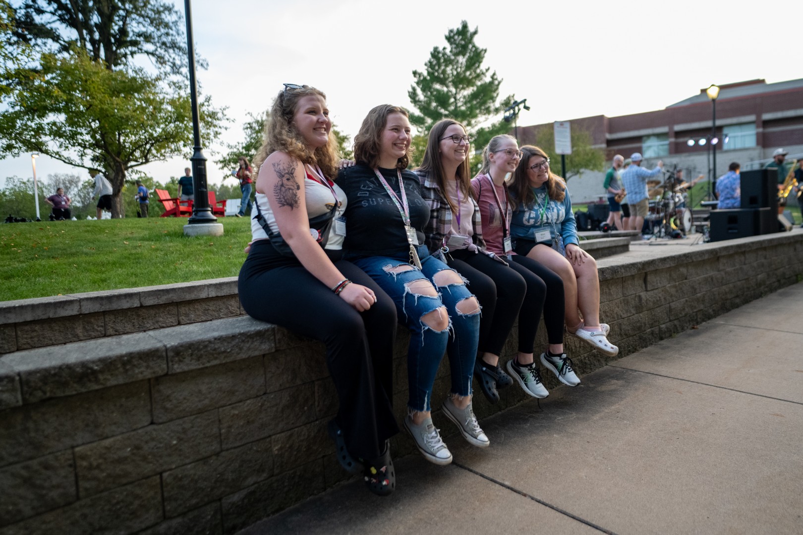 5 students posing on a short wall
