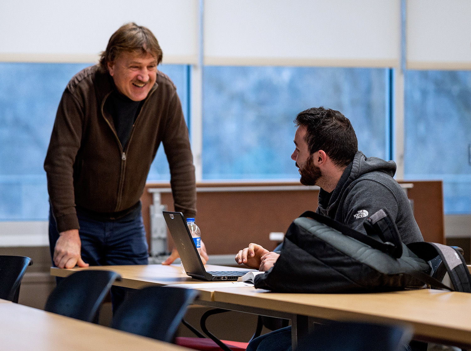 An engineering professor speaks to a student on their laptop