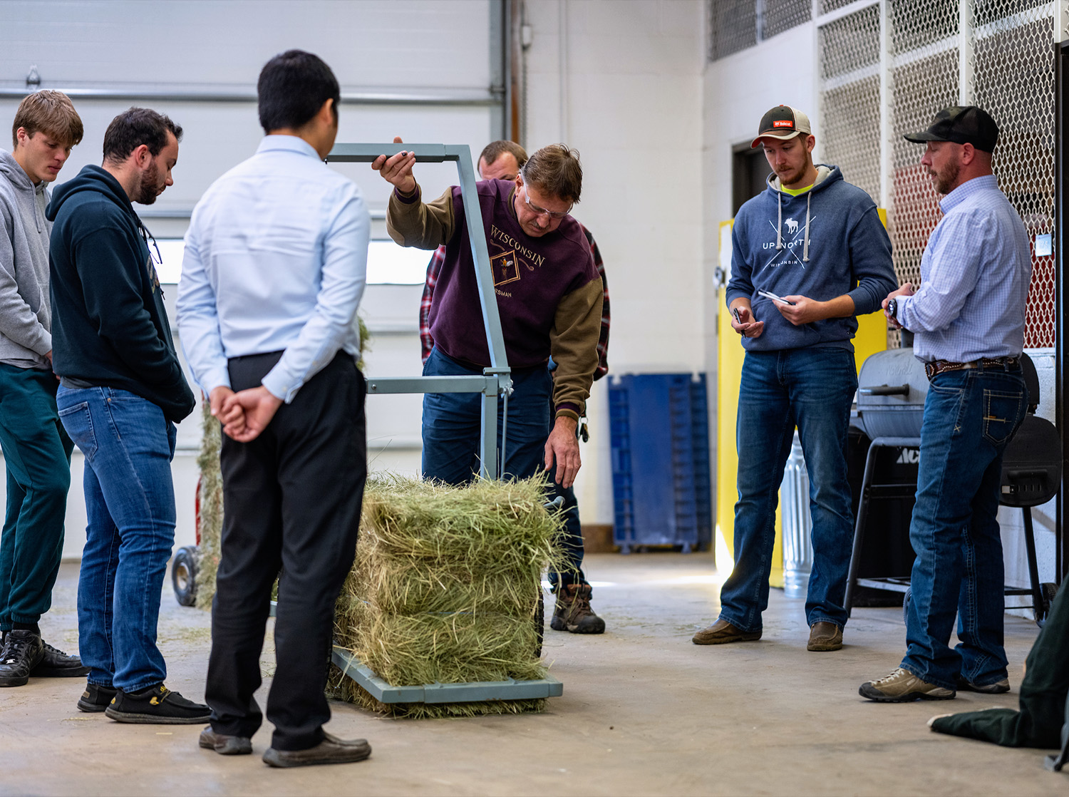 A professor examines a students senior design project