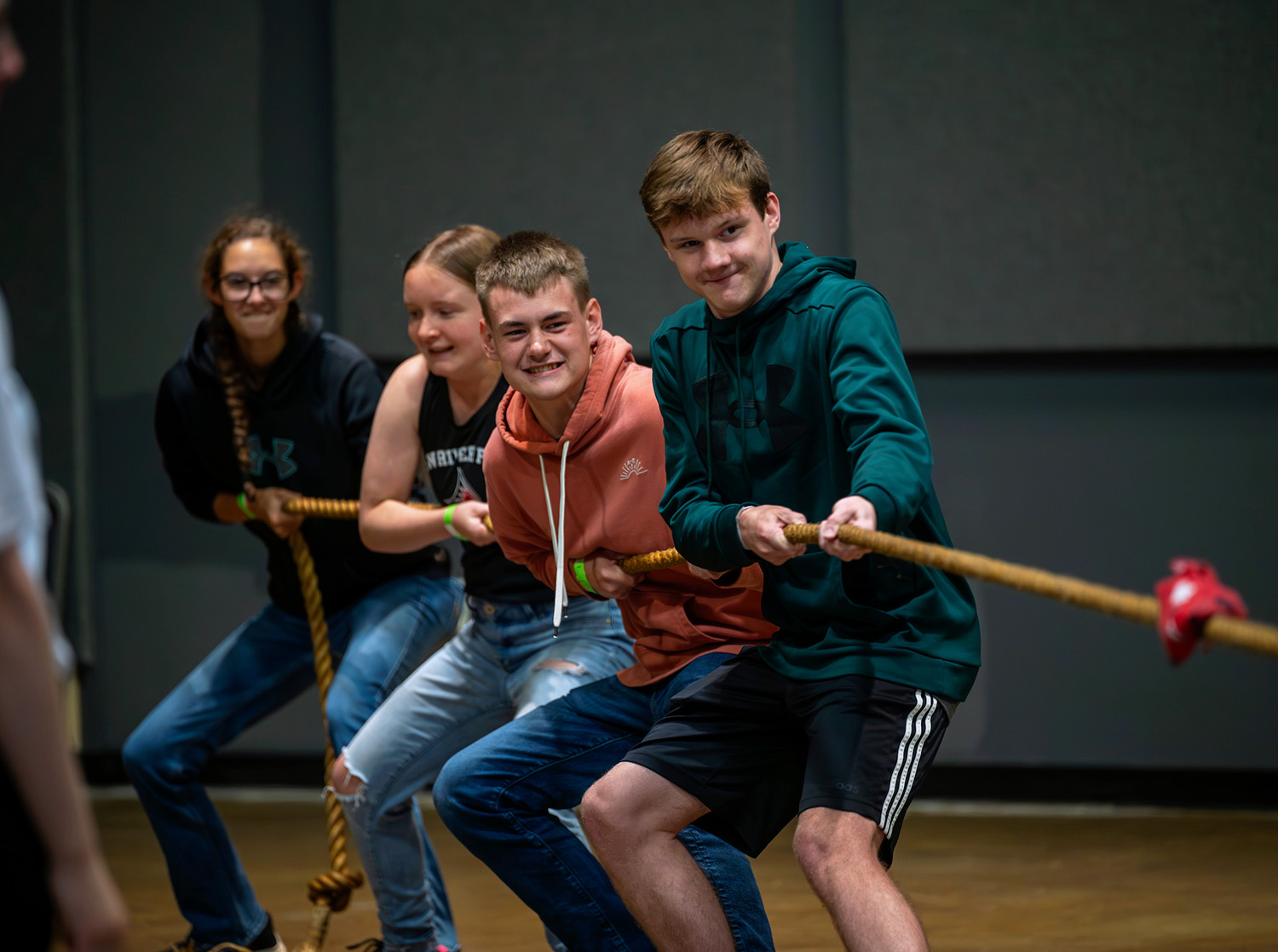 Four students participate in a tug-of-war during homecoming