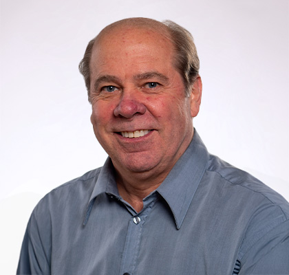 Headshot of Eric Sanden, a man wearing a blue polo shirt