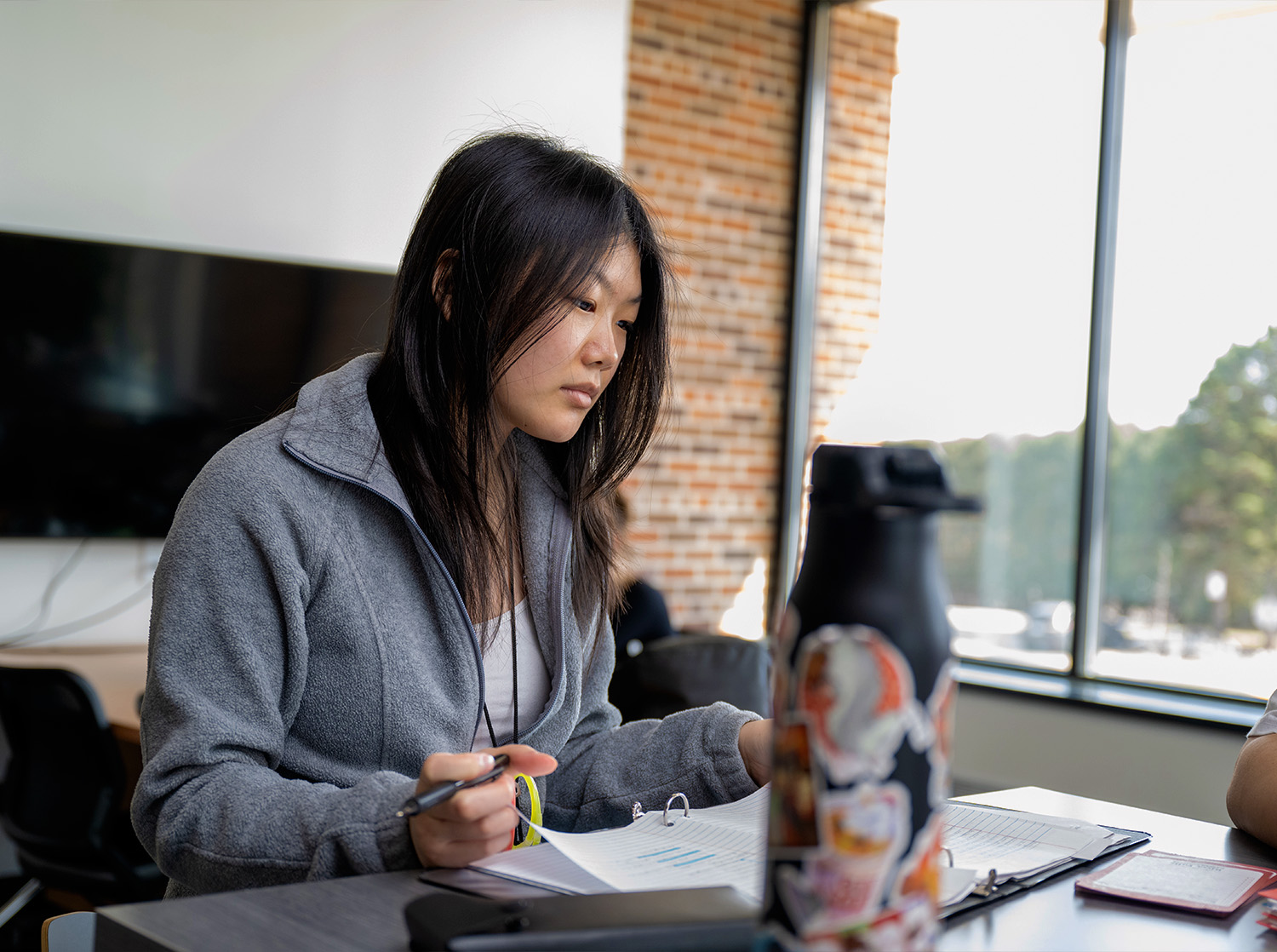 A female student works on their homework in Rodli Hall