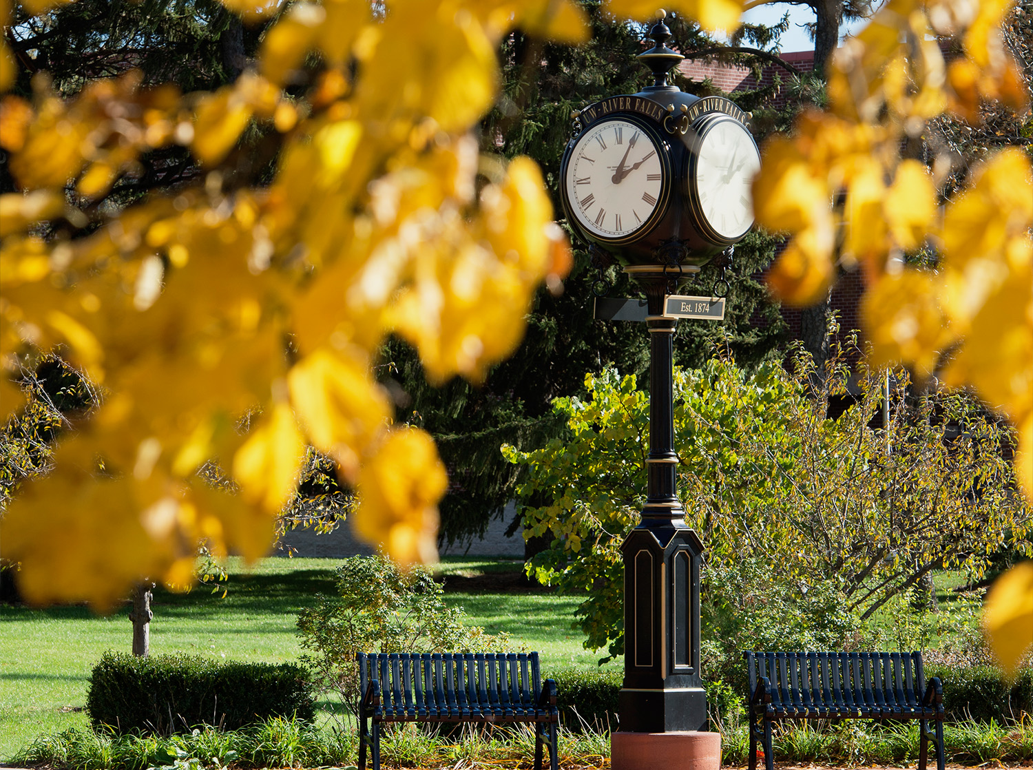 The campus clock with colorful fall leaves