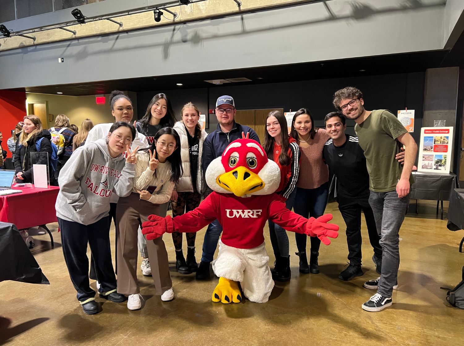 International students posing with the Freddy Falcon mascot