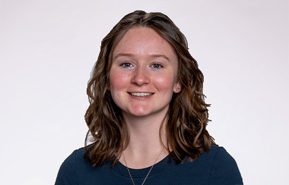 Headshot of Jada Gundersen, a young woman with short brown hair and dark blue shirt