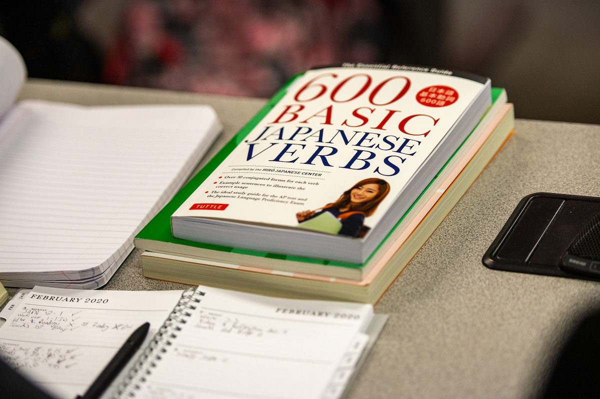 a book with the title "600 basic Japanese verbs" sits on the table