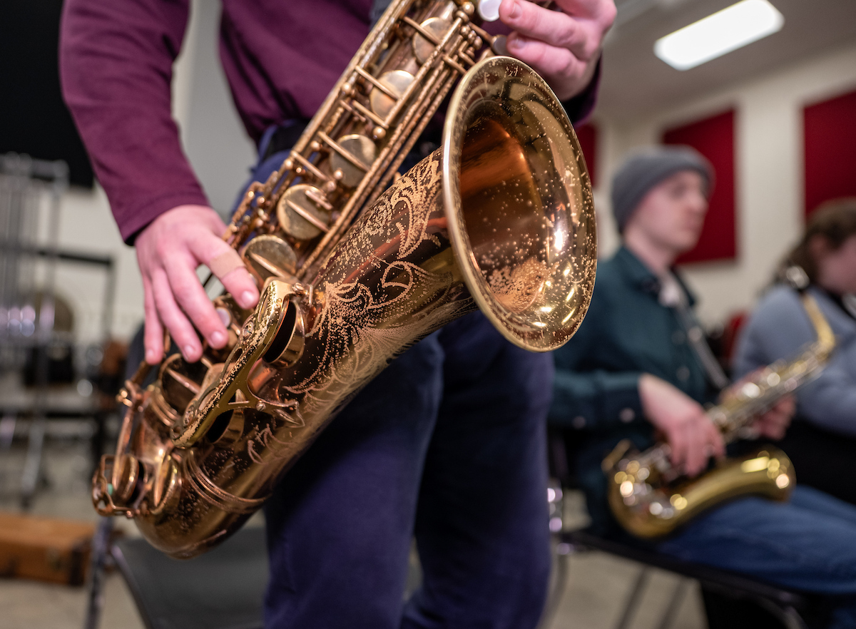 a close up photo of someone playing a baritone saxophone