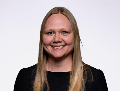 Headshot of Jessie Steenblock. A long blonde haired woman with a black blouse