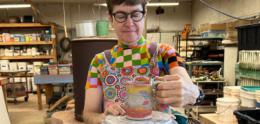 Potter Lisa Orr working on a wheel.