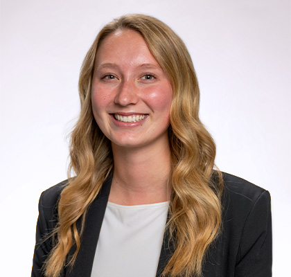 Headshot of Maddie Nelson, a female student with long blonde hair wearing a white blouse and navy blue blazer