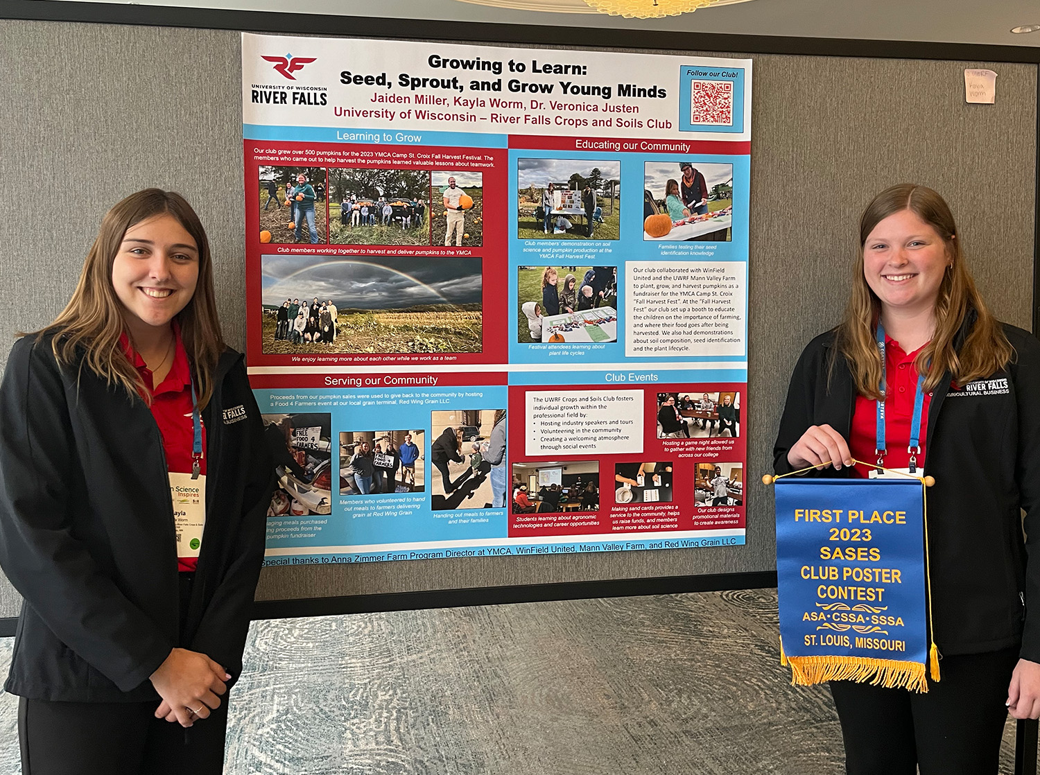 Two female students pose in front of their research poster, one of them holds a ribbon with text "First Place 2023 SASE Poster Contest"