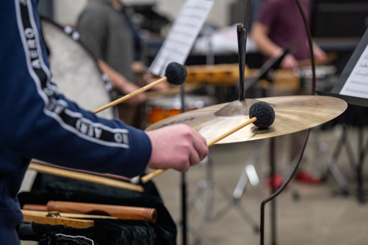 a student plays a percussion instrument