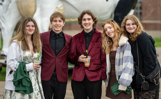5 students posing for a photo outside of the University Center