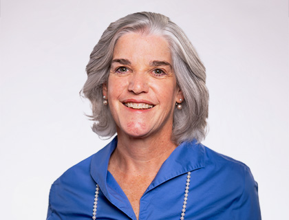 Headshot of Sonja Johnson. A woman with short gray hair and a blue blouse