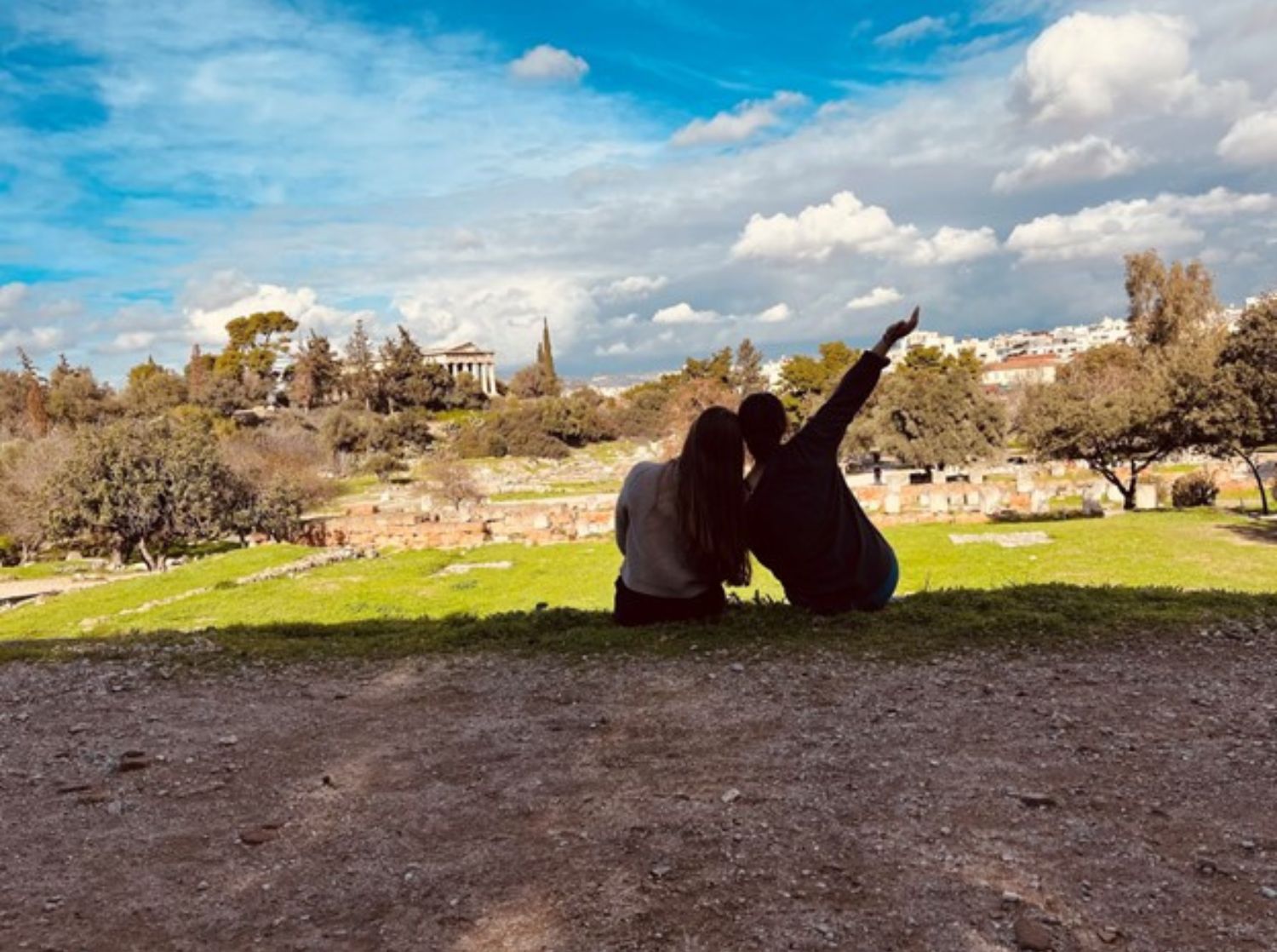 Students linking arms while overlooking a castle