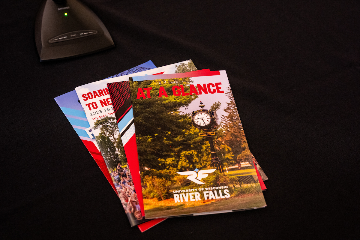 Several UWRF print publications are spread out on a table